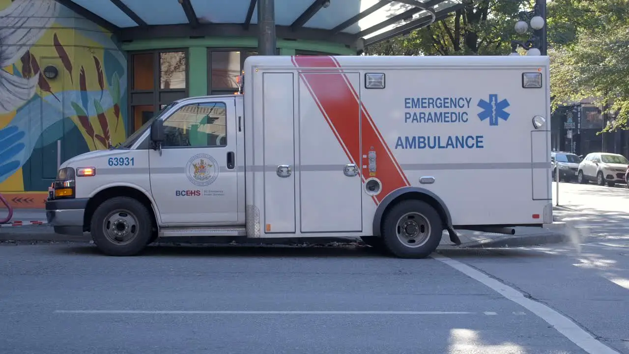 BC Ambulance Service Ground Transport Parked In The Street Outside Bridge Housing for Women Building In Vancouver BC Canada