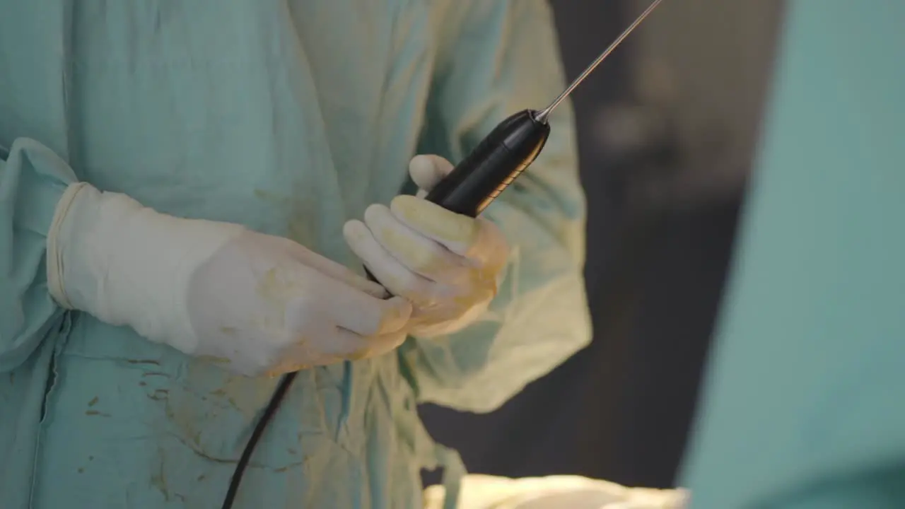 Physician handling a large catheter before surgery showcasing meticulous preparation and expertise for a comprehensive medical procedure