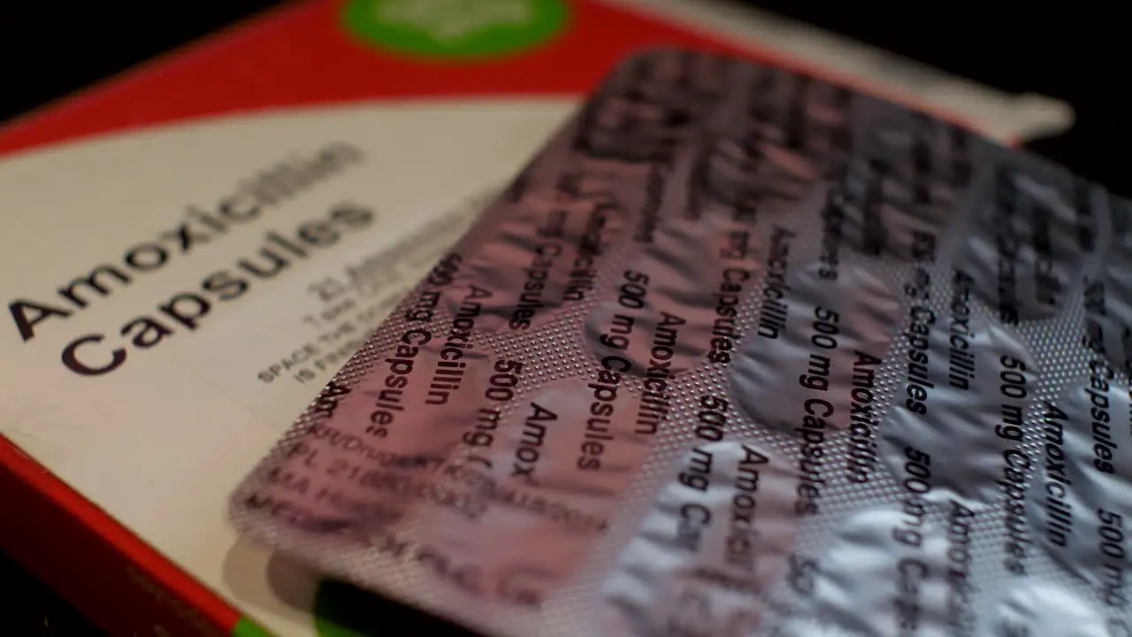 Close-up shot of Amoxicillin antibiotic medication in capsule form with packaging