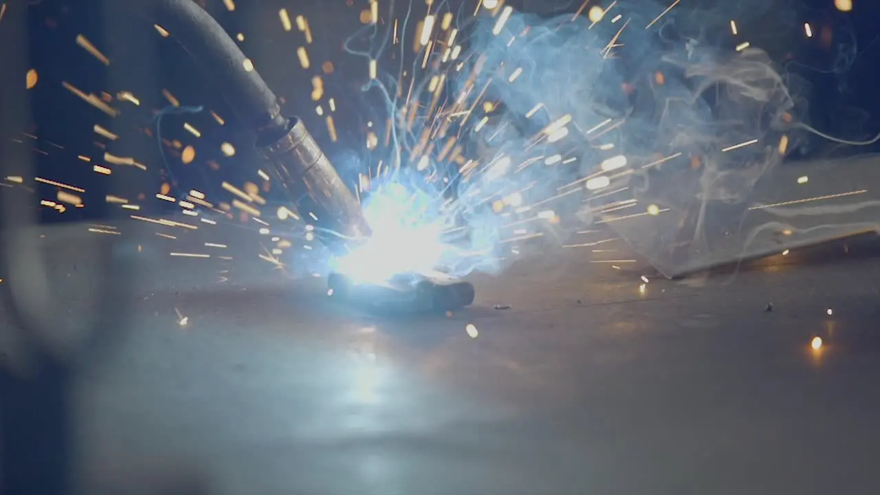 Close Up Shot Of Welding Iron In Workshop Sparks Flying All Around