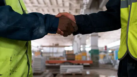 Men shaking hands in a marble factory