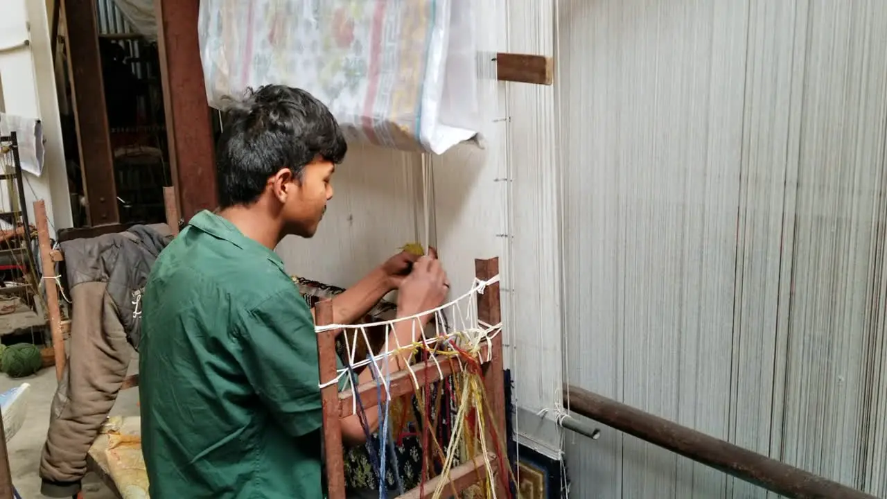 Kathmandu Nepal February 3 2020 A young man weaving rugs on a loom in Kathmandu