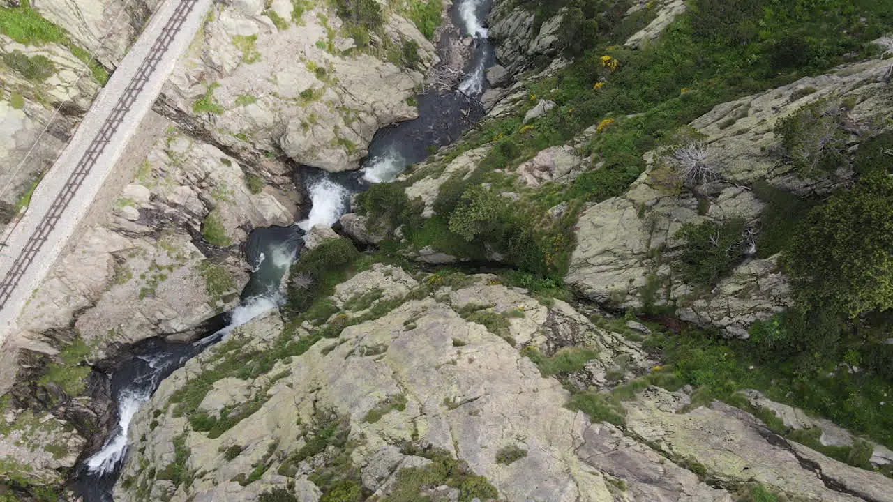 Top Aerial Shot Of A Mountain Gorge Through Which Flows A Rushing River