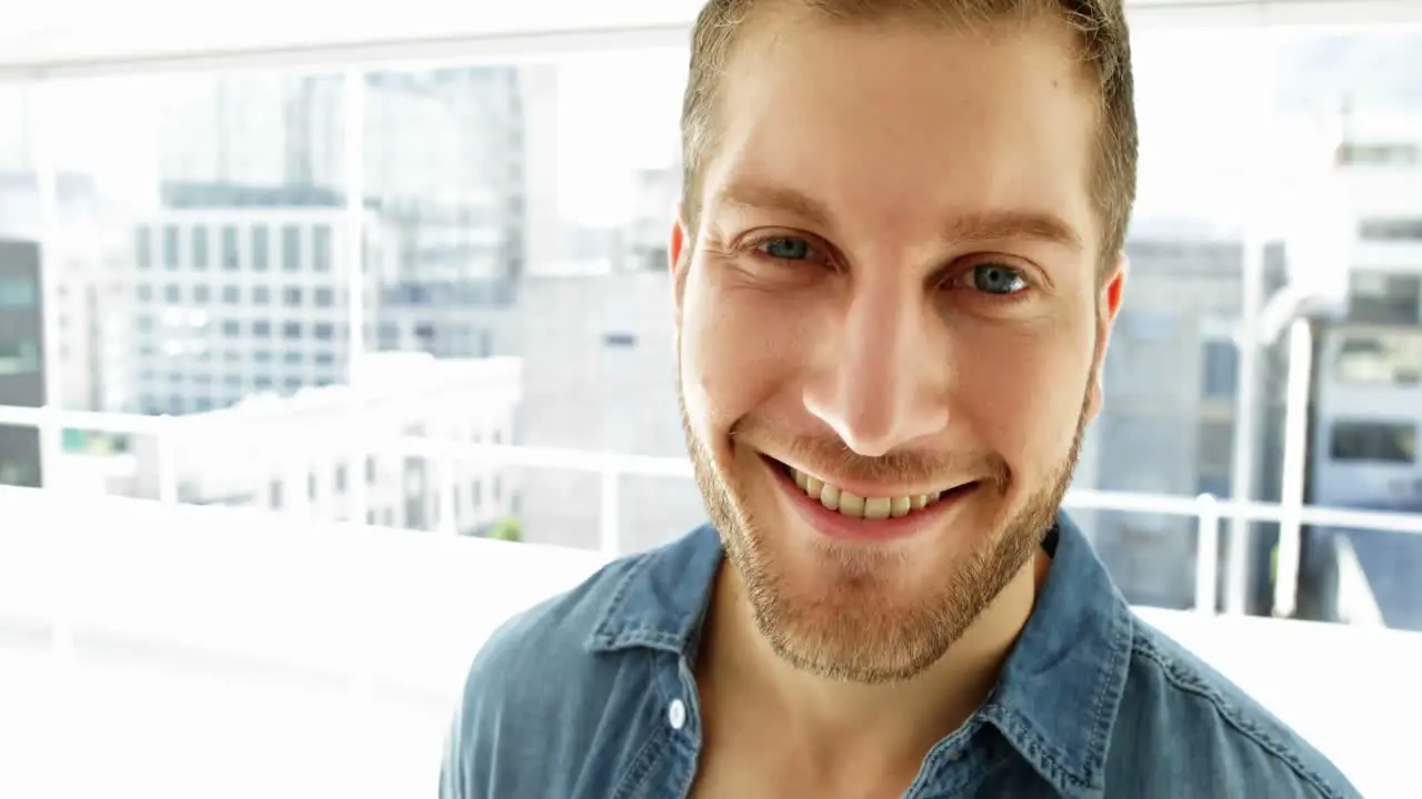 Handsome young man smiling at camera 