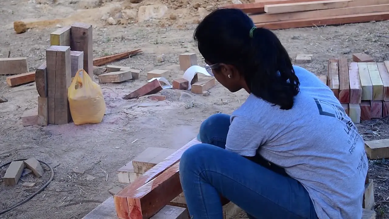 A girl cutting a woodblock at a workshop conducted during an architectural college fest in Kerala