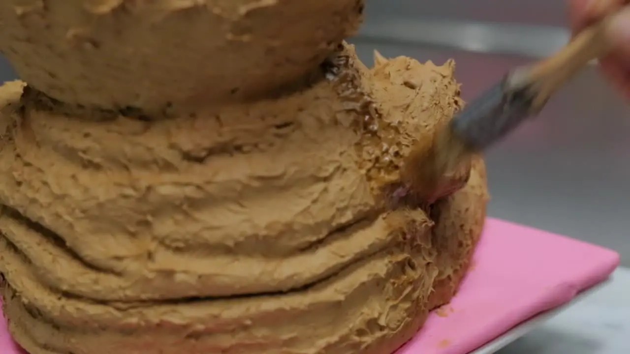 pastry chef icing a teddy bear cake