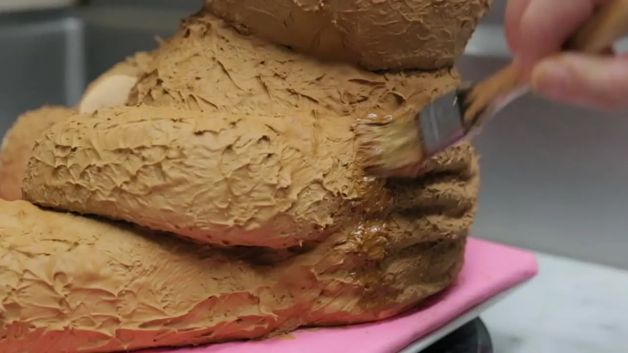 close up of pastry chef icing a children's birthday cake