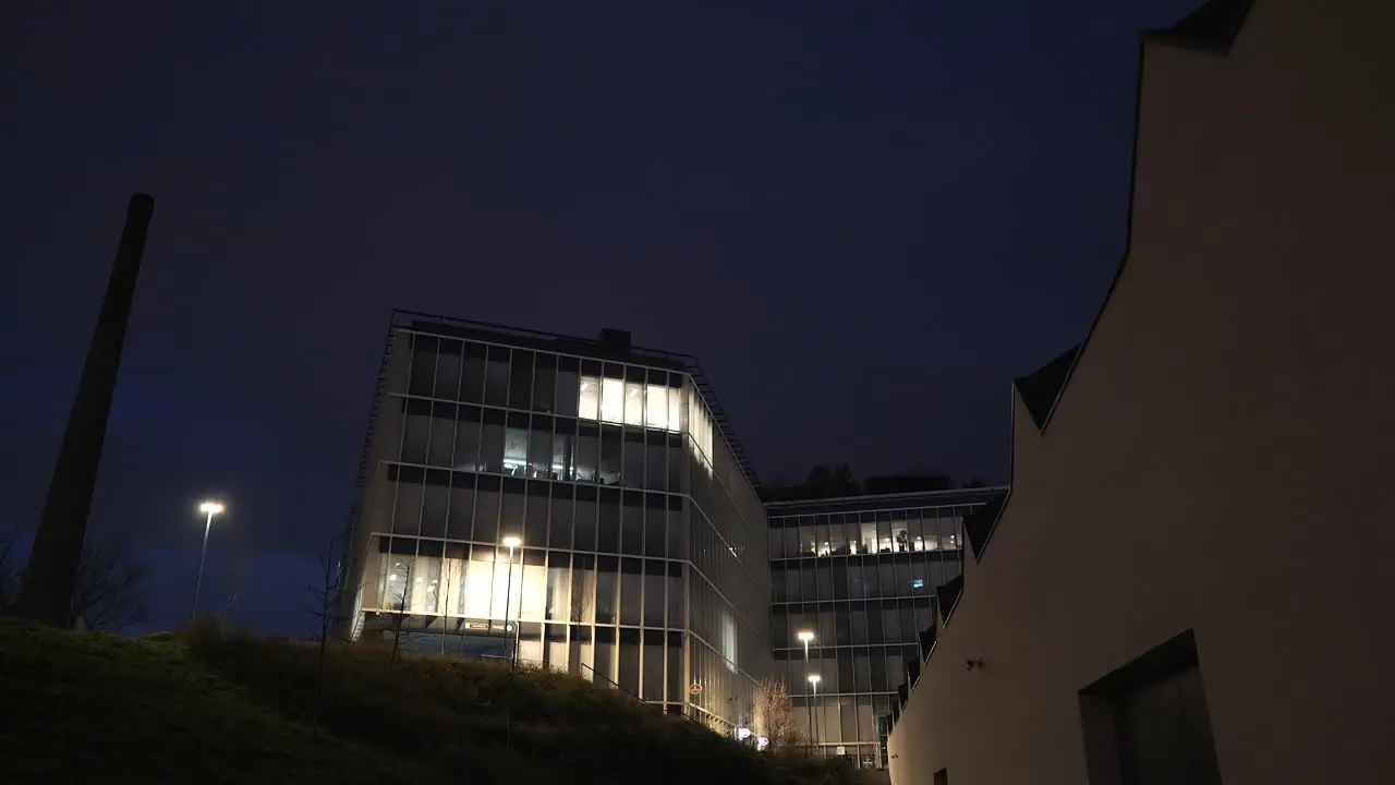 New office park building next to a chimney early morning shot in the dark