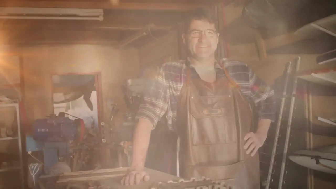 Animation of happy caucasian man in workshop over light spots