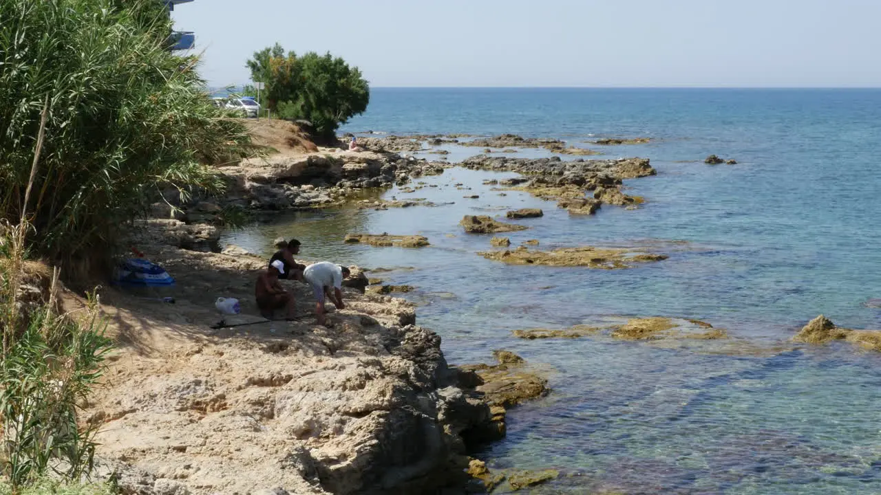 Greece Crete Aegean Sea Fishermen On Rocky Ledge