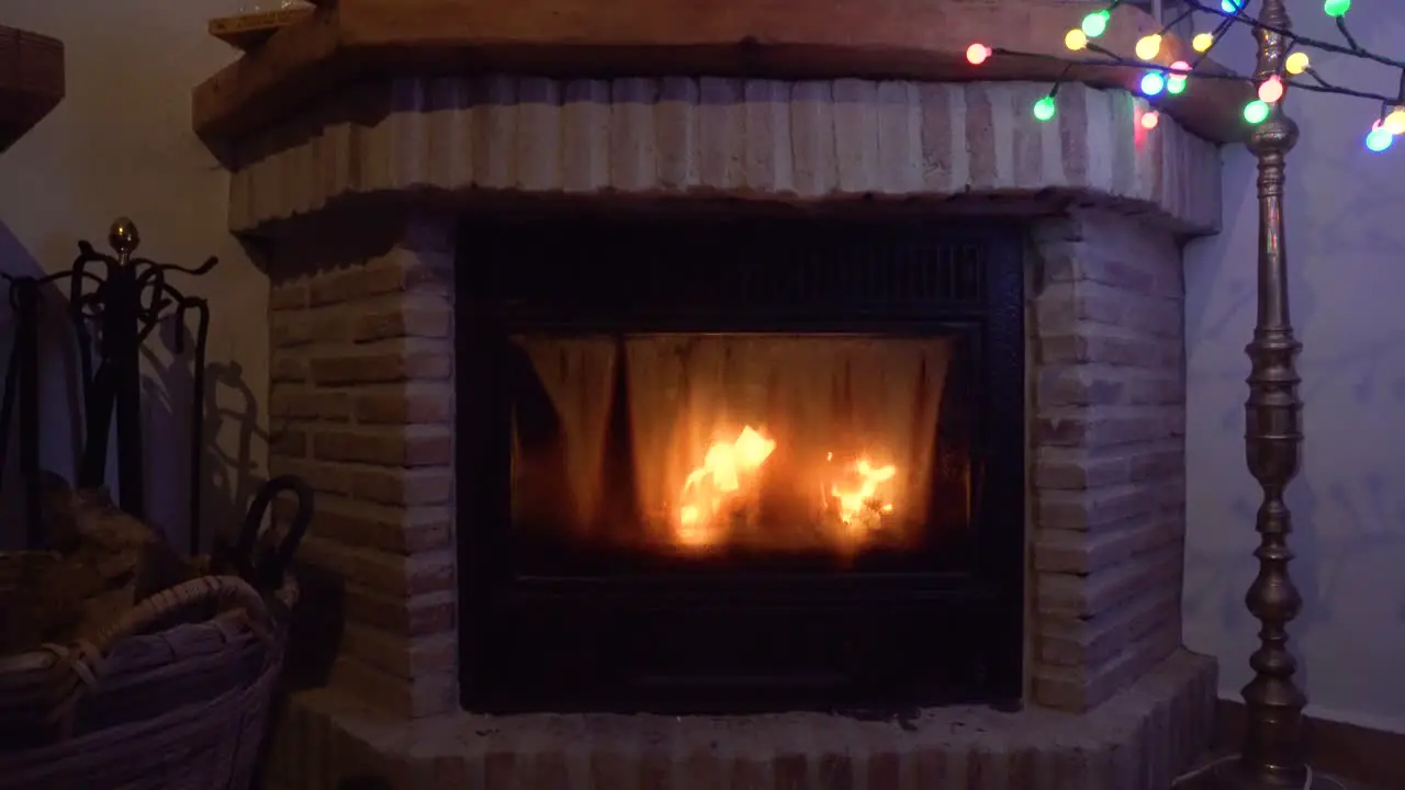 Fireplace with a christmas tree on the top right of the frame