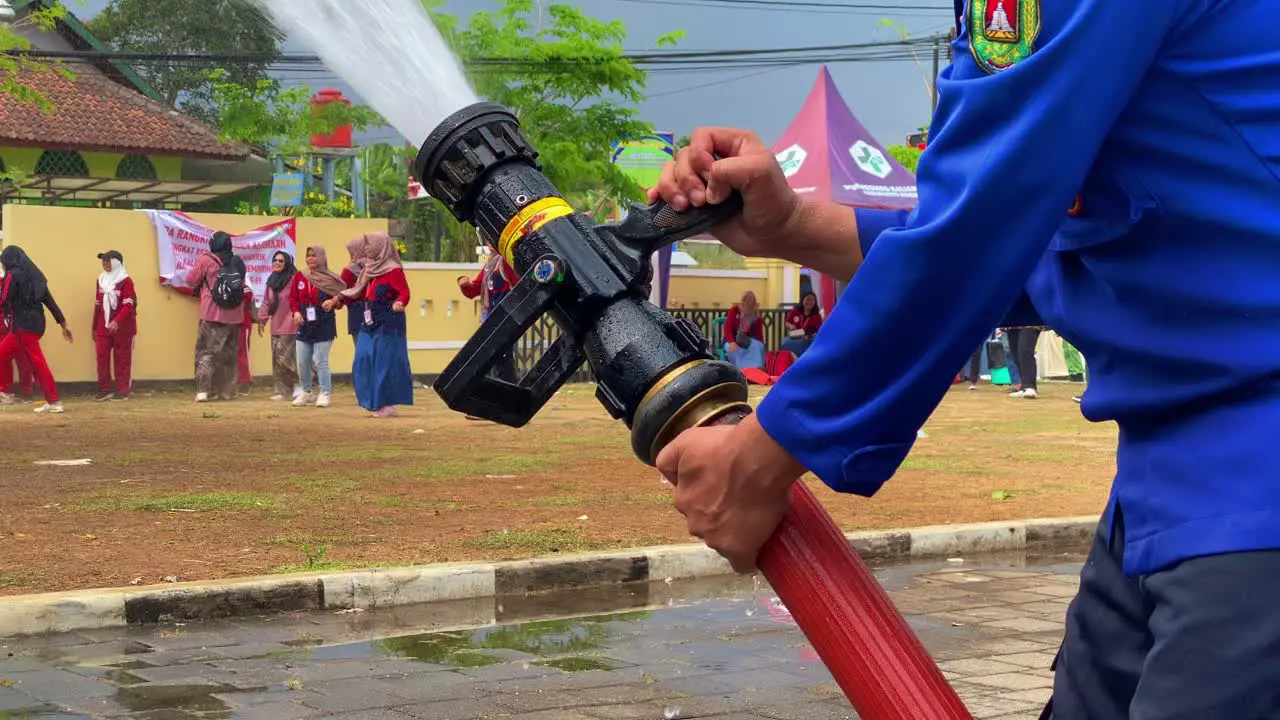 Hand of firefighter holding the fire hose