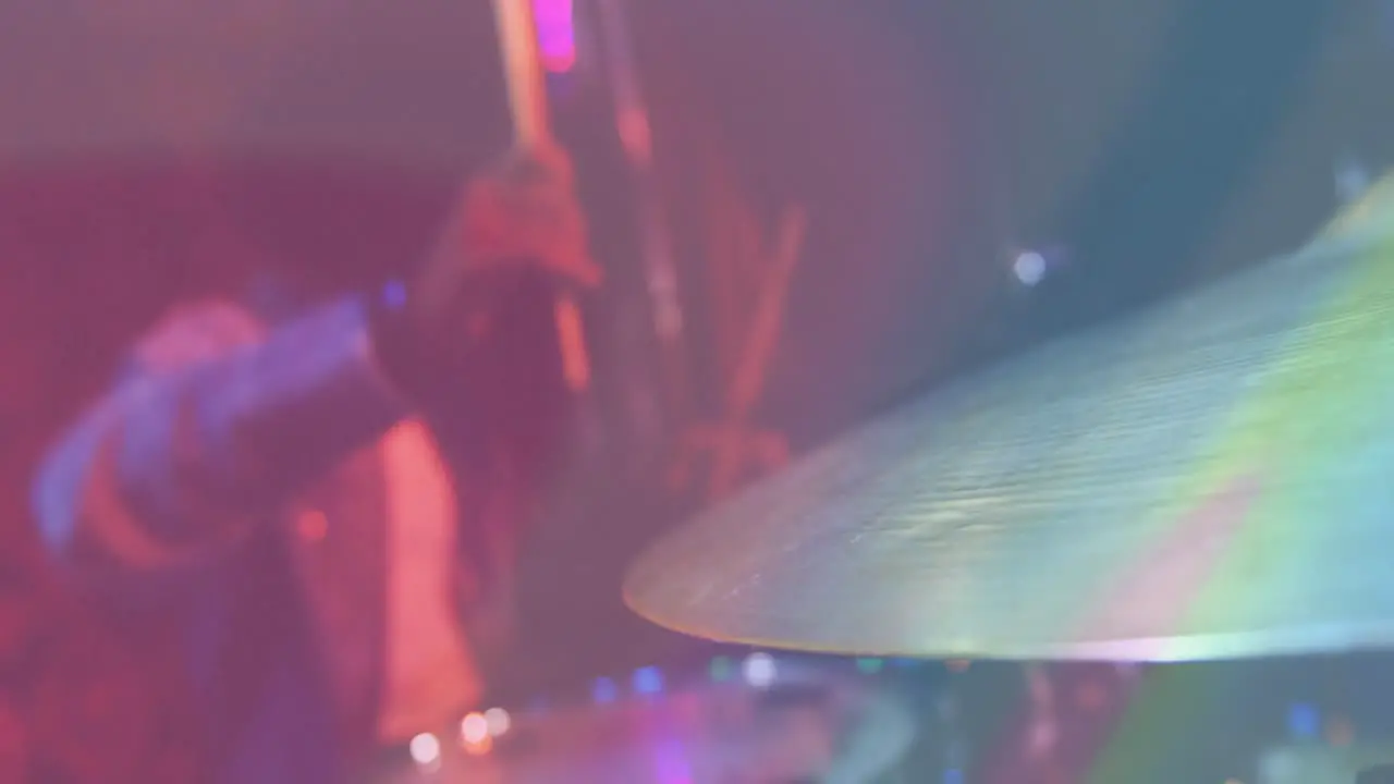 Video of african american male drummer playing drum kit cymbal in foreground