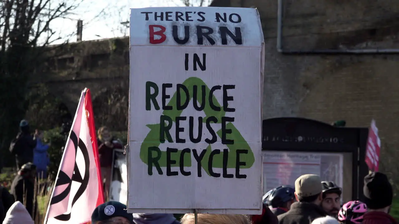 A placard is held up that reads There’s no burn in reduce reuse recycle” at a protest opposing a new waste incinerator at Edmonton