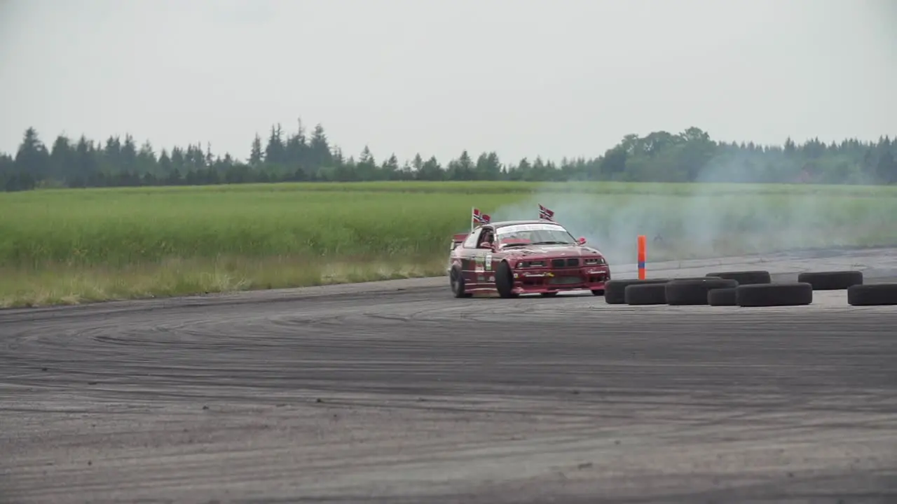 BMW E36 and BMW E30 drifting on a drift track in super slow-motion with lots of smoke from the tyres and close racing