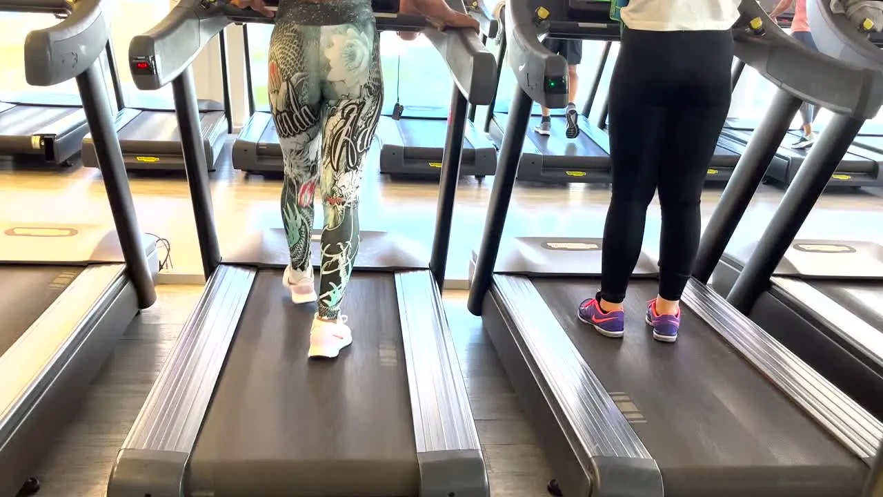 Fit woman engages in an indoor exercise routine on a treadmill at the gym accompanied by relaxing music creating a soothing and invigorating atmosphere