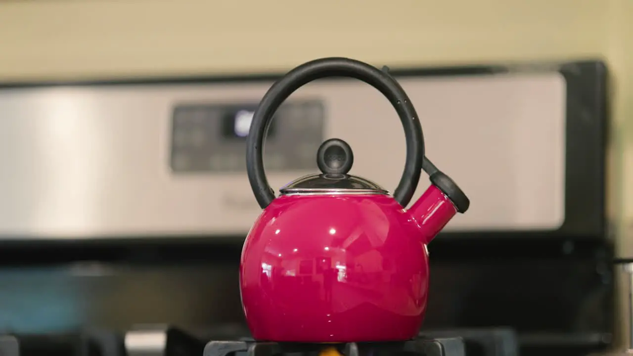 Tea kettle heating up on a stove top