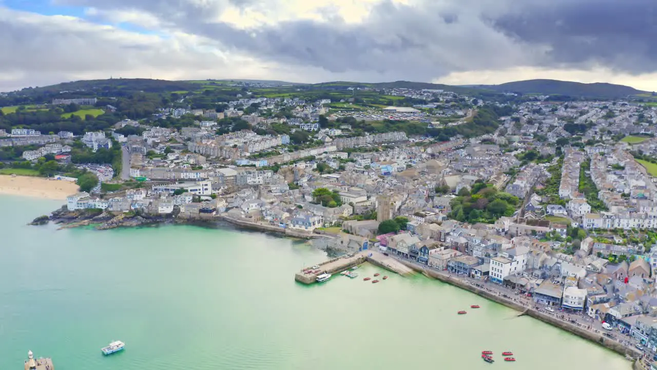 Cinematic aerial view over the town and harbor of St Ives in Cornwall U