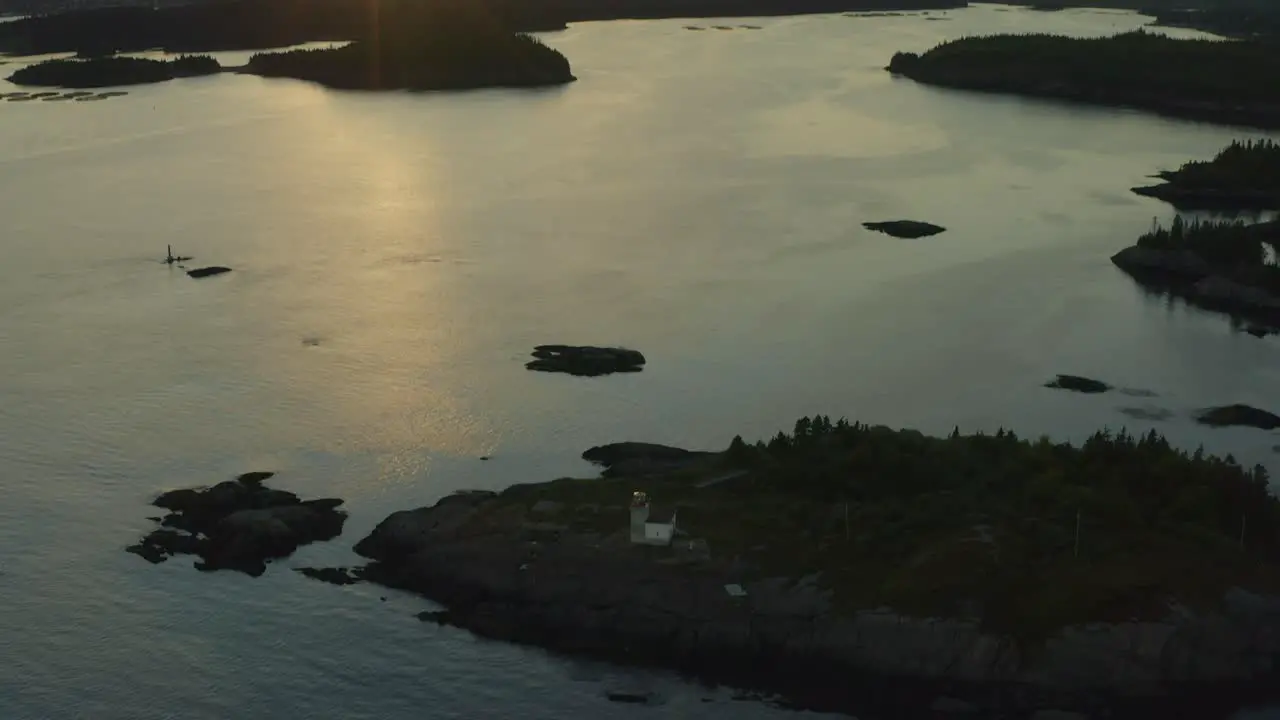 Fly back pan up revealing lighthouse and sunset