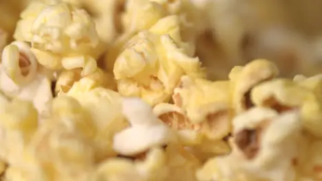 Cinema popcorn background Ready popcorn flakes falling into heap in slow motion