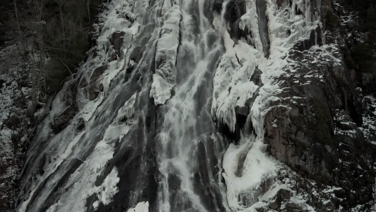 Cascade Falls In Lush Rocky Mountain With Melting Snow In Vallee Bras-du-Nord Canada Tilt-Up Shot