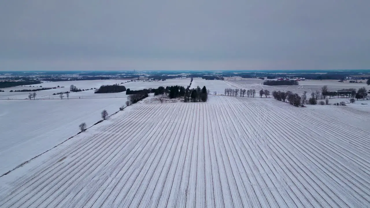 Ploughed field Snow covered farm in London Canada farm landscape with aerial drone view 60fps