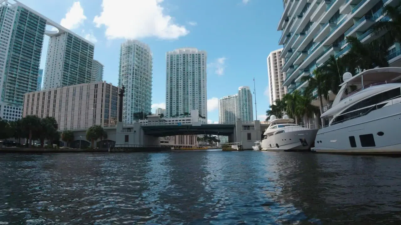 tall buildings and yachts line the coast of the waterways in Miami Florida