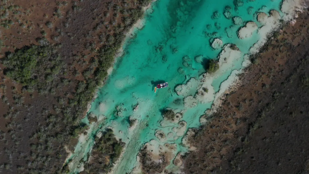 Rotating descending shot of a boat in a tropical waters in Mexico South America