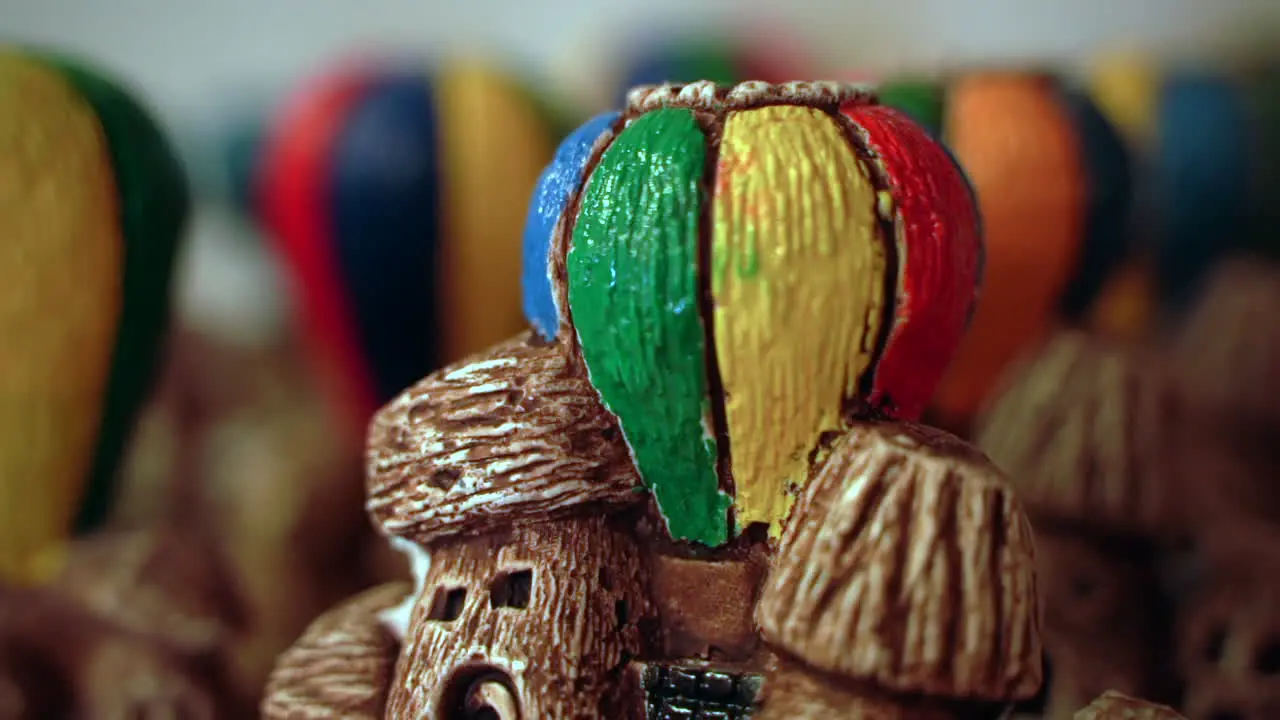 Closeup of miniature ornament hot air balloons and fairy chimneys coming in and out of focus