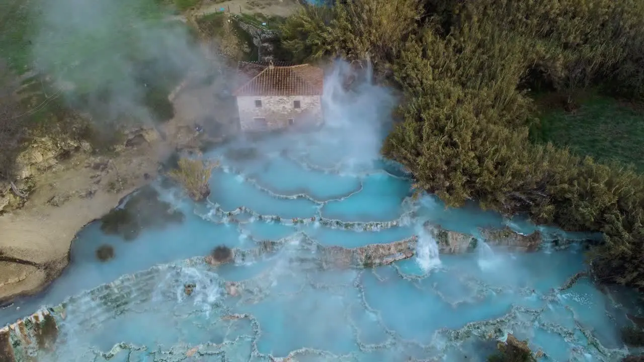 The geothermal hot springs bath and waterfall at Saturnia Tuscany Italy close to Siena and Grosseto at sunrise from above