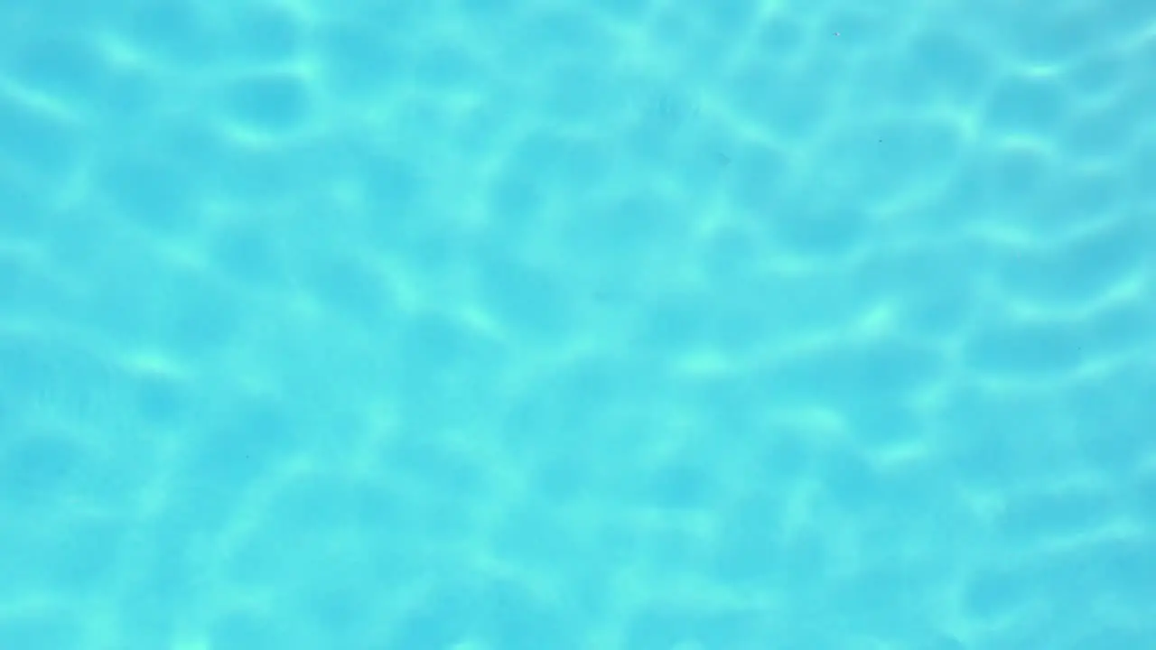 Light glimmering on blue swimming pool