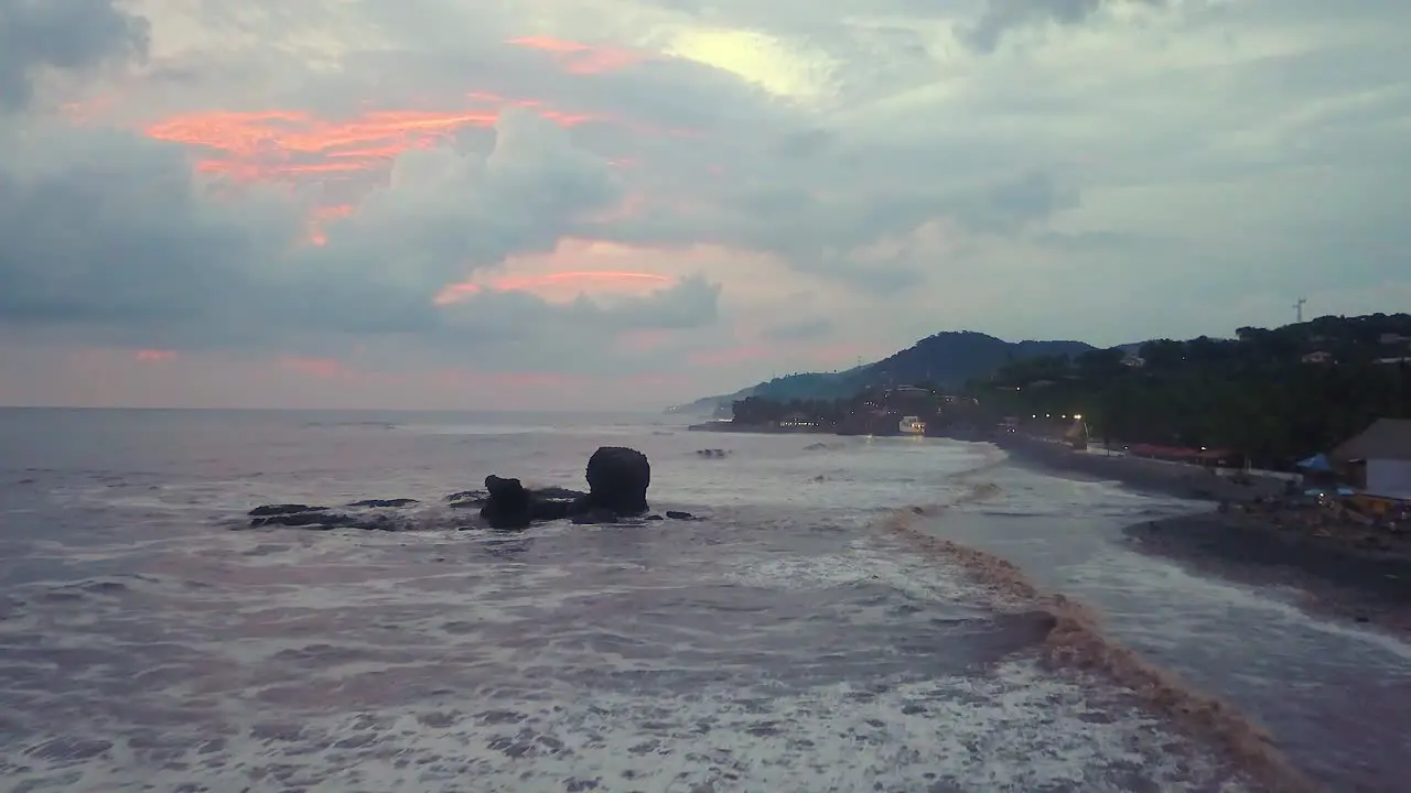 El Tunco beach famous rock formation during an overcast afternoon in El Salvador Drone dolly out