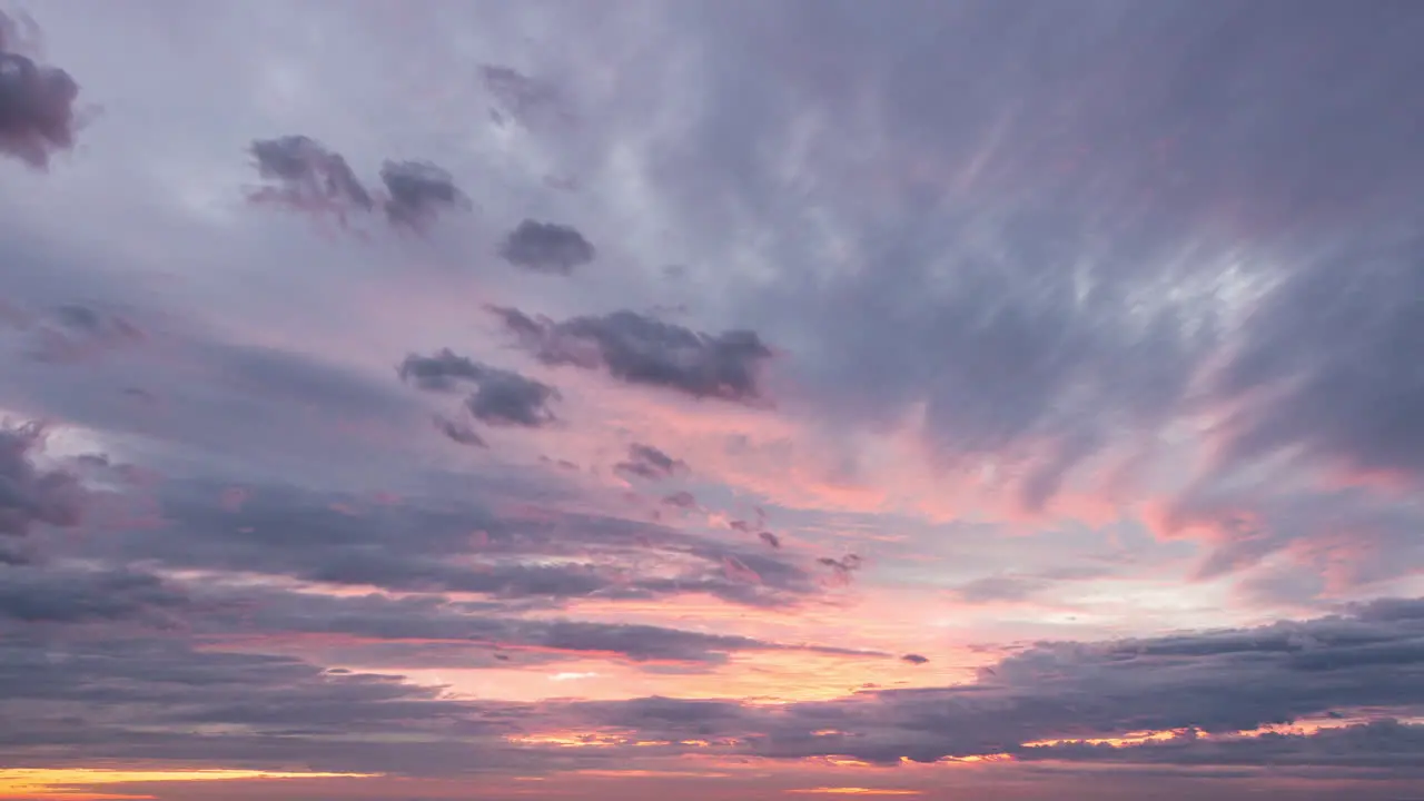 Colourful sunset time lapse of cloud layers forming and decaying