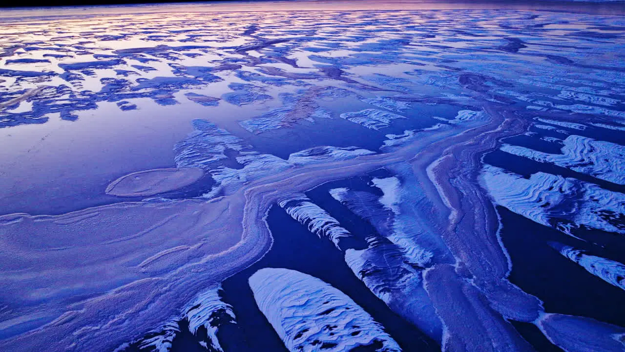 Colorful ice on top of river on cold winter day