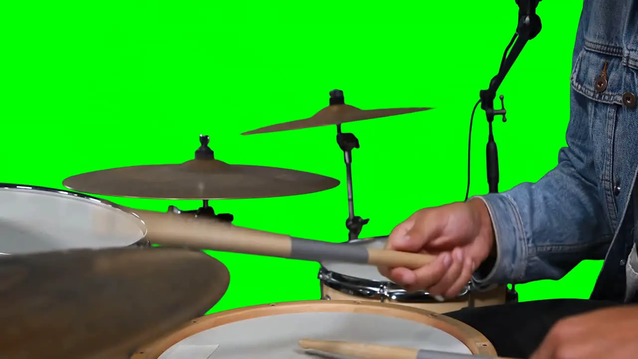 Mid section of drummer playing drum