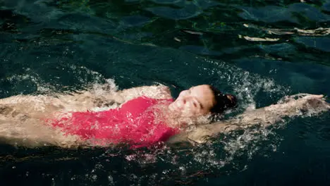 Woman swimming backstroke