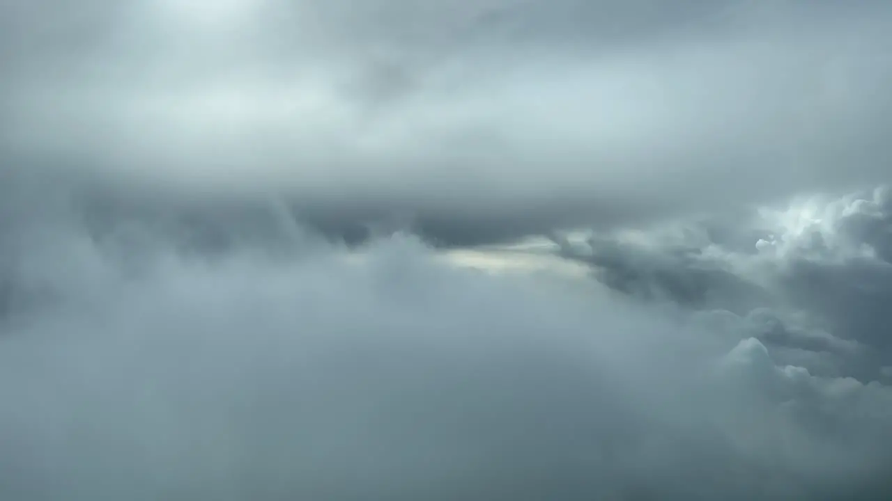 Awesome aerial pilot point of view flying through a turbulent and stormy sky looking for a gap through the clouds to avoid problems