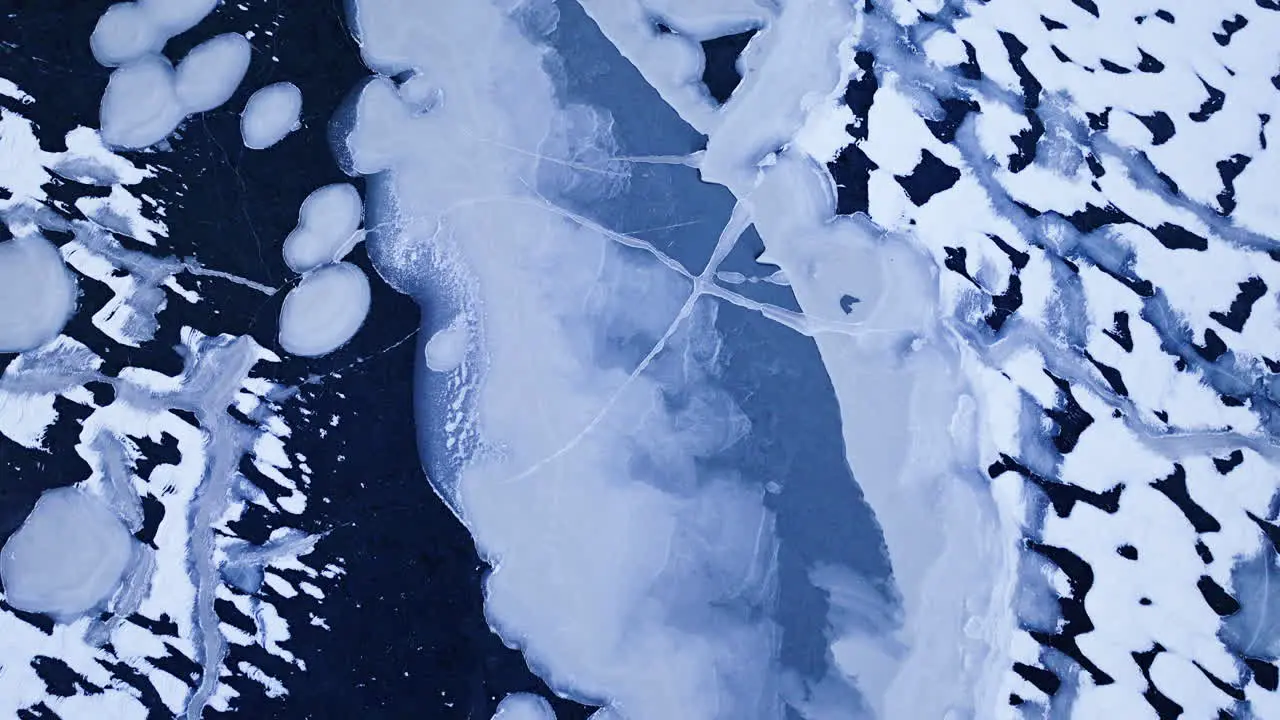 Video from a drone as it soars above enormous ice formations in the water