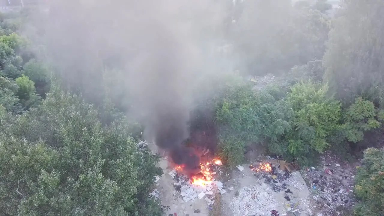 Fire spreading through the surrounding garbage