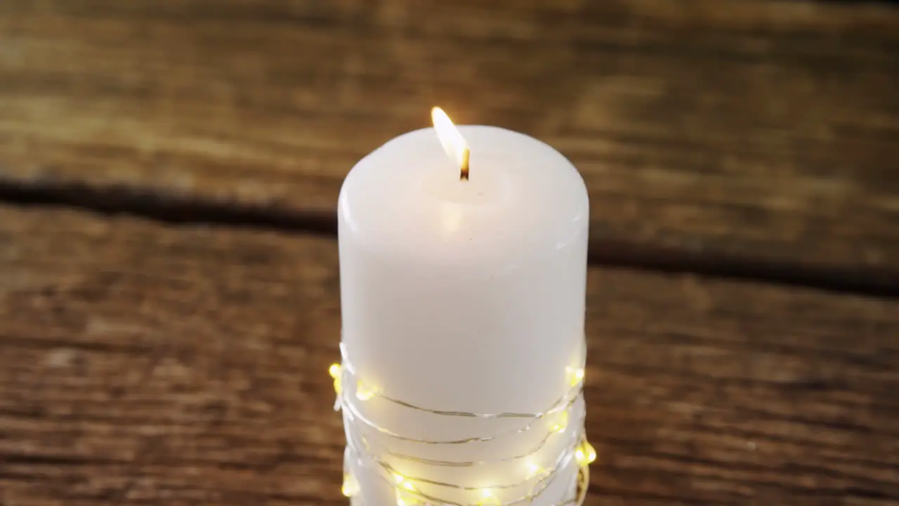 Burning candles on wooden table 4k