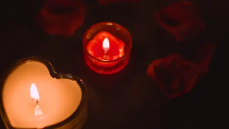 Overhead Shot Of Romantic Heart Shaped Lit Red Candles On Background Covered In Rose Petals 1