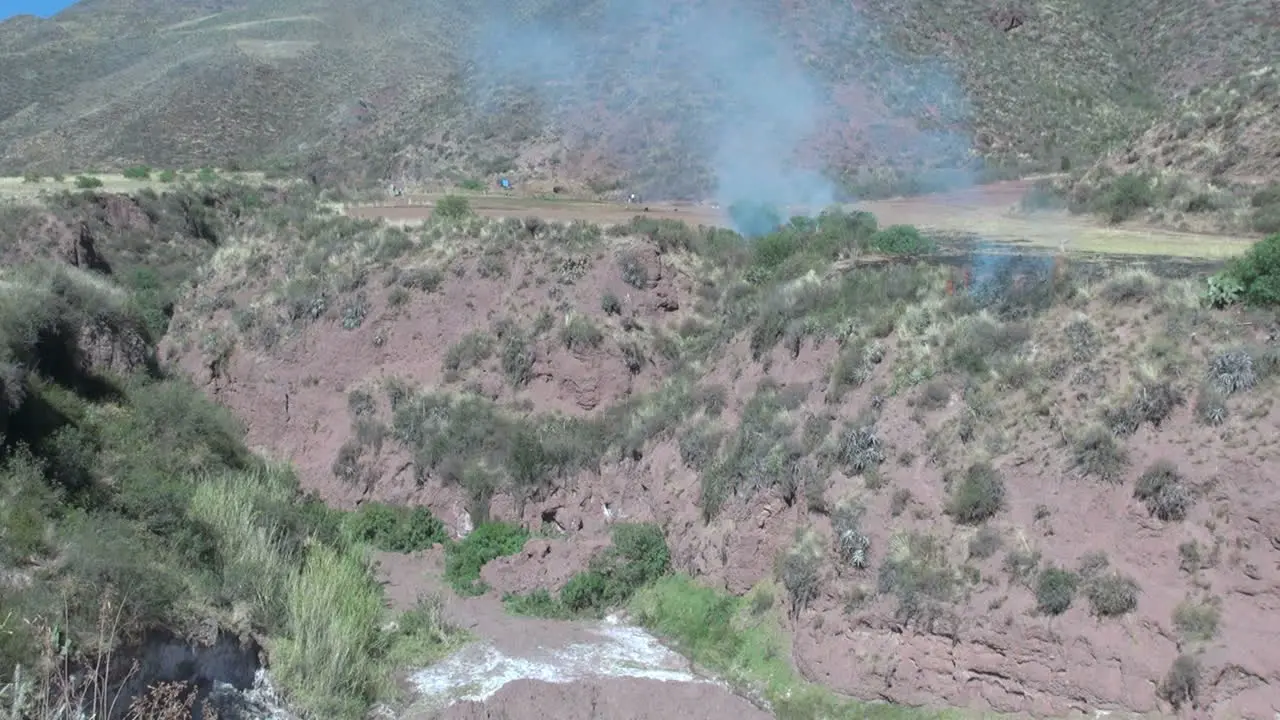 Peru Sacred Valley blue smoke drifts over a ravine 12