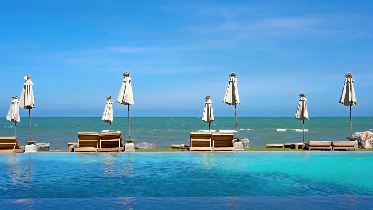 Umbrella around outdoor pool nearly sea ocean