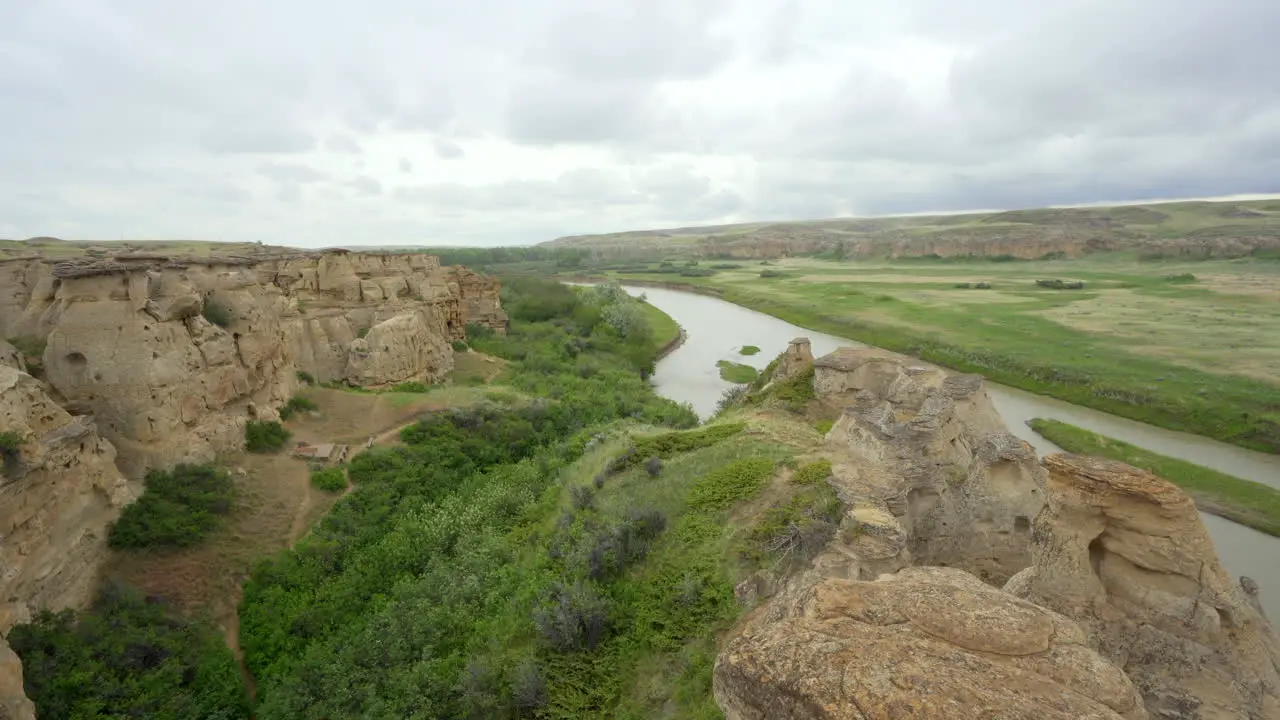 Bandlands and Hoodoos with river in a desert in Alberta Canada during overcast day