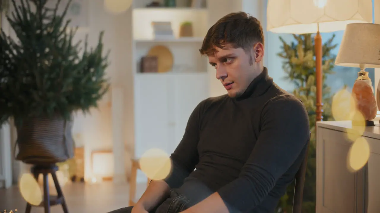 Young man sitting on chair in living room