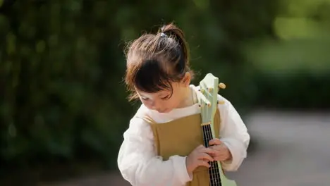 Child with musical instrument outdoors