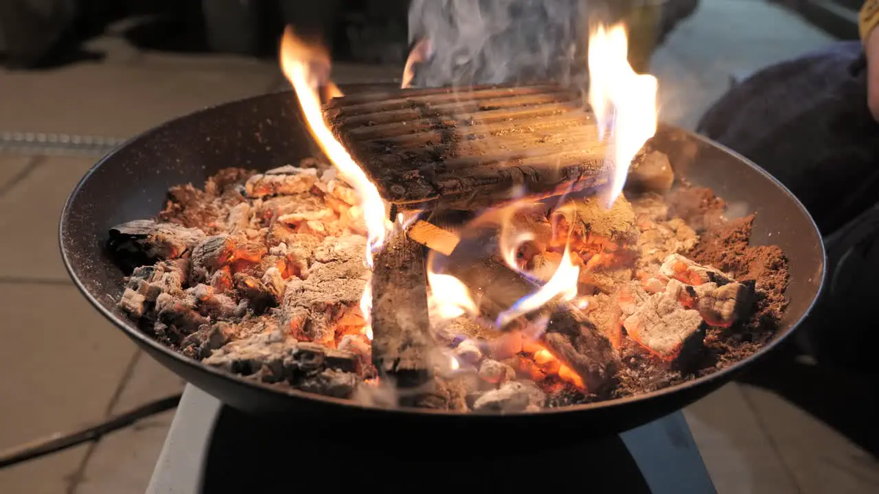 A burning fire pit on a patio