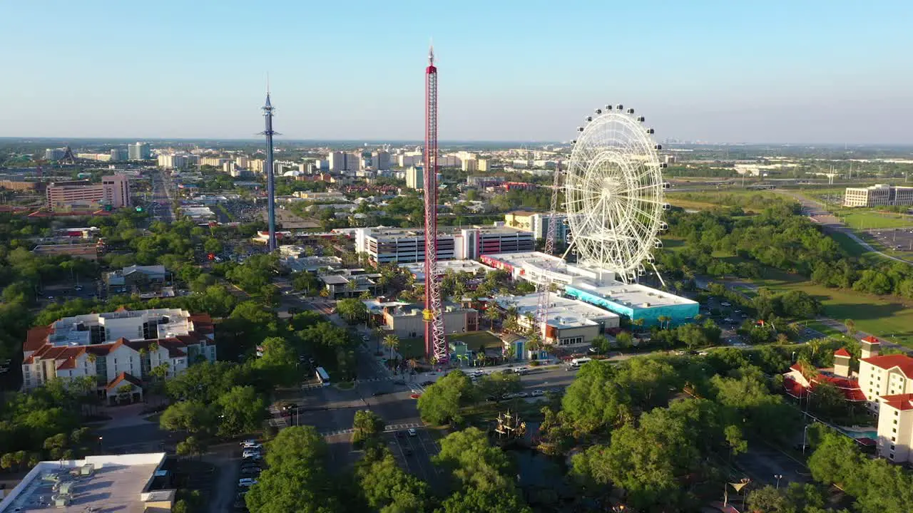 4K Cinematic drone panning over the thrill rides at ICON Park including the Freefall Sling Shot Star Flyer and the Ferris Wheel on I-Drive