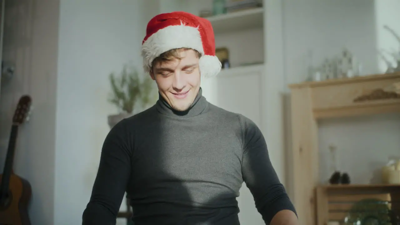 Man wearing Santa cap while sorting glowing lights