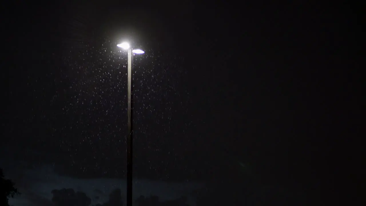 City lights during rain and lightning at night